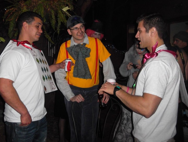 Tweetledee (or dum?) flanked by two guests who dared enter without costume. They were punished and adorned with deck of cards sandwich boards.